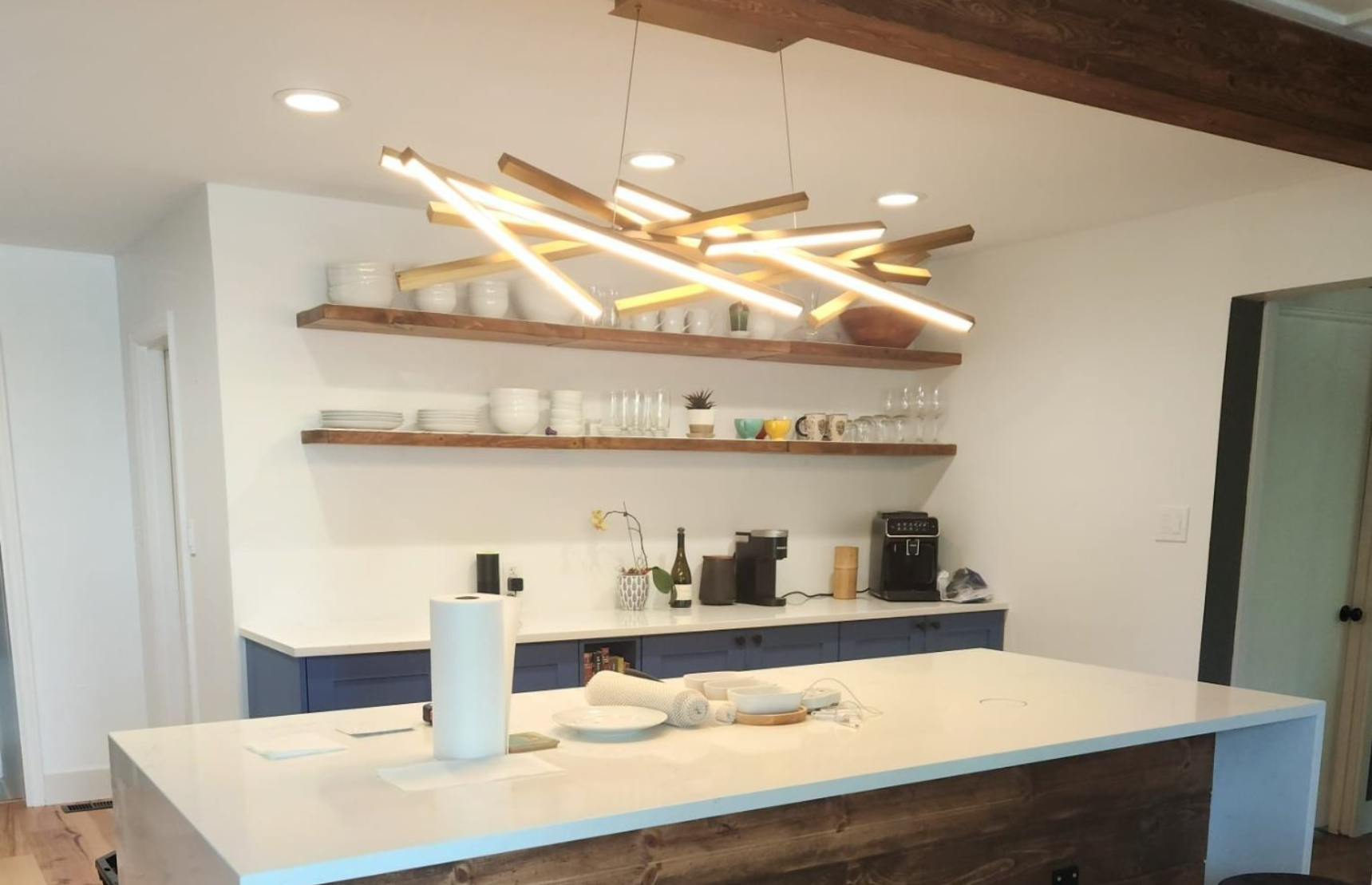 Kitchen bar with reclaimed wood front and beam lighting