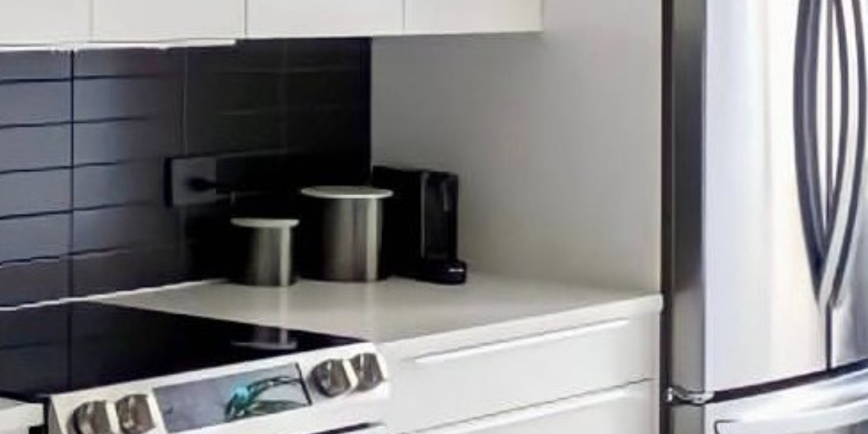 White kitchen with black stacked tile backsplash after remodel